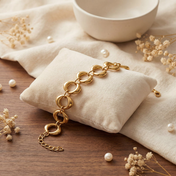 Anti-Tarnish Gold Plated Viya Aurelia Loop Bracelet by House of Viya on beige cushion with pearls and dried flowers