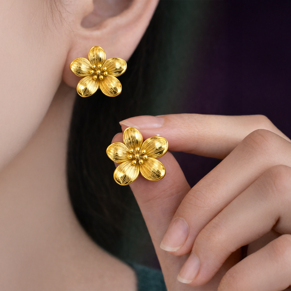 Woman wearing gold plated flower stud earrings - anti-tarnish daily wear jewelry by House of Viya