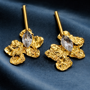 Gold Plated Abstract Floral Crystal White Earrings close-up on dark blue fabric - House of Viya