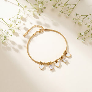 Gold Plated Snake Chain Bracelet with White Heart and Square Baguette Stone Dangling Charms