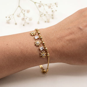 Gold Plated Snake Chain Bracelet with Starburst Floral Motif and White Baguette Stone Dangling Charms
