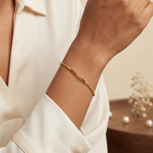 Woman wearing Anti-Tarnish Gold Plated Plain Celeste Bar Bracelet on wrist - House of Viya gold jewellery