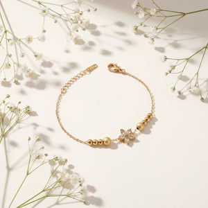 Gold Plated Beaded Stretch Bracelet with White Stone Floral Star Charm