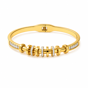 Gold bracelet with diamond accents on a white background