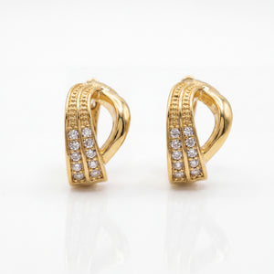 Gold hoop earrings with diamond accents on a white background