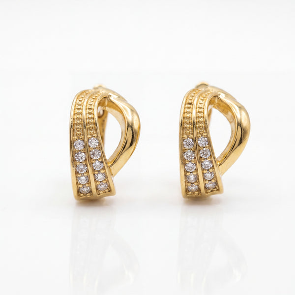 Gold hoop earrings with diamond accents on a white background