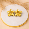 Stainless steel gold plated flower stud earrings on white stone surface - House of Viya