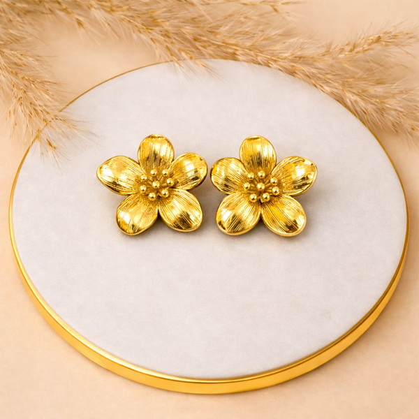 Stainless steel gold plated flower stud earrings on white stone surface - House of Viya