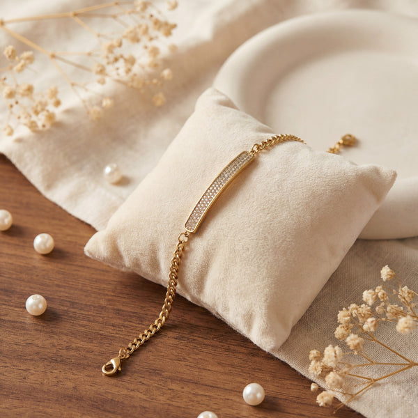 Anti-Tarnish Gold Plated Celeste Bar CZ Stone Bracelet by House of Viya on cushion with pearls and dried flowers