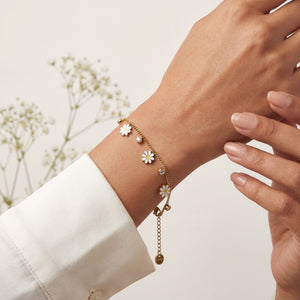 Gold Plated Curb Chain Bracelet with Dangling White Enamel Daisy Flower Charms and Stone Accents