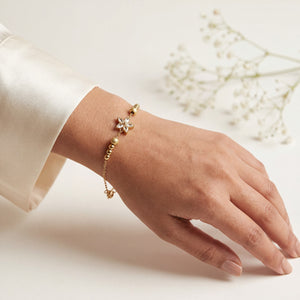 Gold Plated Beaded Stretch Bracelet with White Stone Floral Star Charm