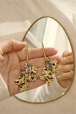 Anti-Tarnish Gold Plated Abstract Floral White Crystal Earrings held in hand in front of mirror - House of Viya