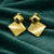 Anti-Tarnish Gold Plated Gold Stud with Gold Square Earrings by House of Viya on green fabric background