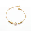 Gold Plated Beaded Stretch Bracelet with White Stone Floral Star Charm