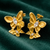 Anti-Tarnish Gold Plated Hanging 2 Butterfly Earrings by House of Viya on green fabric background