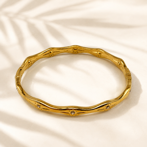 Gold Wavy Ripple Edge Scattered Diamond Oval Kada for Women | Curved Band Stone Stainless Steel Ladies Bangle | Artistic Festive Jewellery