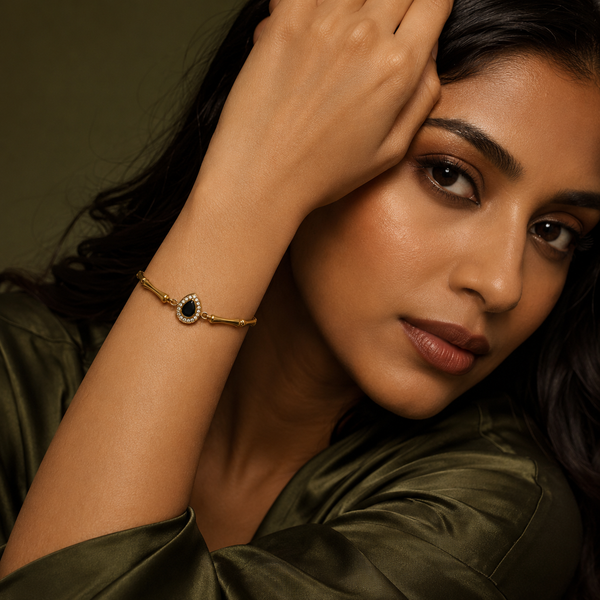 Gold Plated Bamboo Bar Link Bracelet with Oval Black Stone Halo Centrepiece and Lobster Clasp