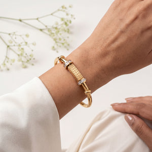 Gold plated barrel centrepiece baby kada bangle worn on wrist – styling shot House of Viya